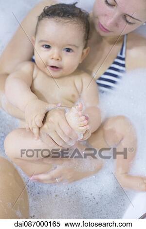 Mother and baby soaking in bathtub together View Large Photo Image Stock Photography - Mother and baby soaking in bathtub together. Fotosearch
