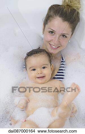 Mother and baby taking a bubble bath together View Large Photo Image Picture - Mother and baby taking a bubble bath together. Fotosearch