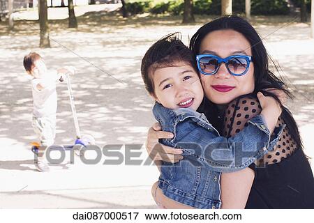 Mother and daughter embracing outdoors View Large Photo Image Stock Photo - Mother and daughter embracing outdoors. Fotosearch