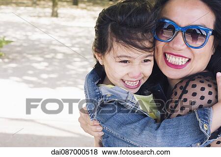 Mother and daughter embracing outdoors, portrait View Large Photo Image Stock Photo - Mother and daughter embracing outdoors, portrait. Fotosearch