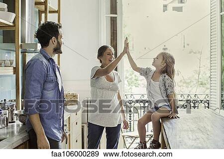 Mother exchanging high five with daughter View Large Photo Image Stock Photo - Mother exchanging high five with daughter. Fotosearch