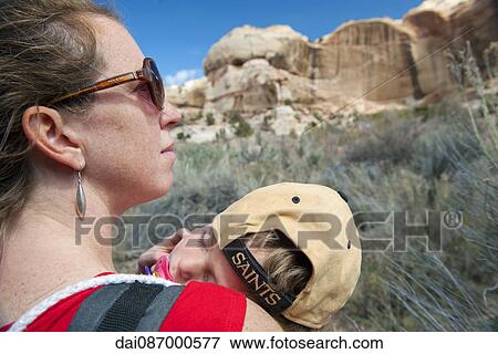 Mother hiking in nature, carrying sleeping son View Large Photo Image Stock Photo - Mother hiking in nature, carrying sleeping son. Fotosearch
