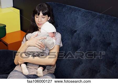 Stock Photo - Mother holding infant. Fotosearch