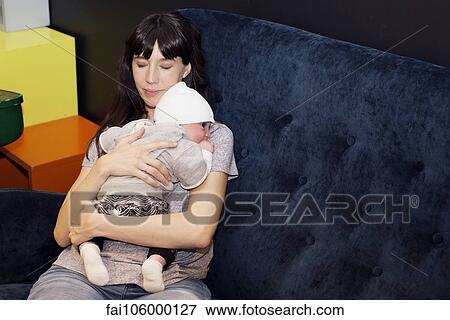 Stock Photo - Mother holding infant. Fotosearch
