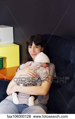 Mother holding sleeping infant View Large Photo Image Stock Photo - Mother holding sleeping infant. Fotosearch