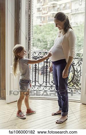 Mother preparing daughter for arrival of her new sibling View Large Photo Image Stock Image - Mother preparing daughter for arrival of her new sibling. Fotosearch