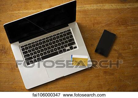 Online banking using laptop computer or smartphone View Large Photo Image Stock Photo - Online banking using laptop computer or smartphone. Fotosearch