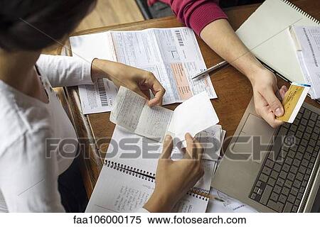 Organizing expense receipts and bills View Large Photo Image Stock Photography - Organizing expense receipts and bills. Fotosearch