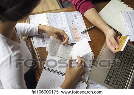 Organizing expense receipts and bills View Large Photo Image Stock Photography - Organizing expense receipts and bills. Fotosearch