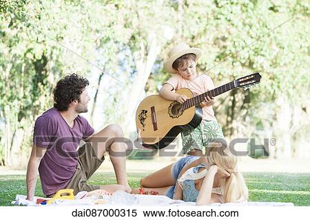 Parents teaching son how to play guitar View Large Photo Image Stock Photography - Parents teaching son how to play guitar. Fotosearch