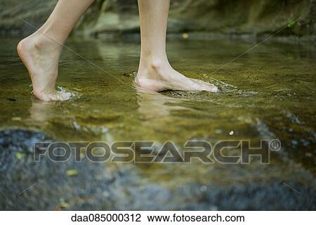 Person wading barefoot in stream, cropped View Large Photo Image Stock Image - Person wading barefoot in stream, cropped. Fotosearch
