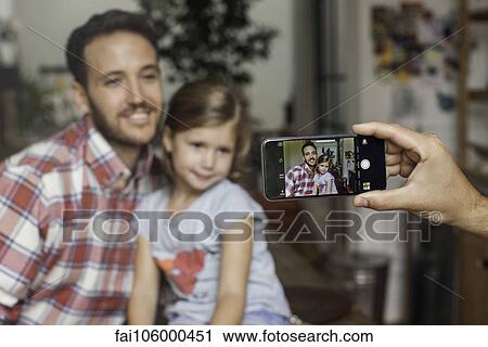 Photographing father and daughter with smartphone View Large Photo Image Stock Image - Photographing father and daughter with smartphone. Fotosearch