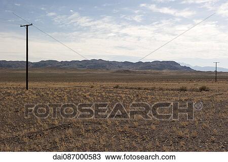 Power lines running through arid landscape View Large Photo Image Stock Image - Power lines running through arid landscape. Fotosearch