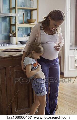 Pregnant mother preparing daughter for arrival of new sibling View Large Photo Image Stock Photo - Pregnant mother preparing daughter for arrival of new sibling. Fotosearch