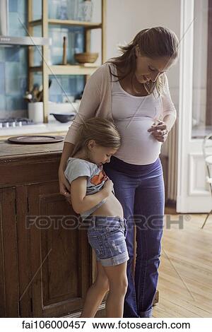 Pregnant mother preparing daughter for arrival of new sibling View Large Photo Image Stock Photo - Pregnant mother preparing daughter for arrival of new sibling. Fotosearch