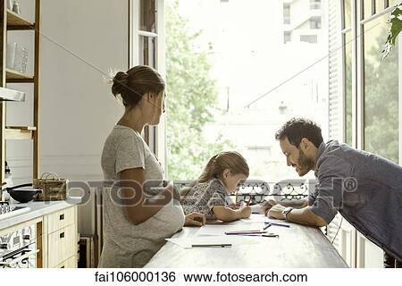Pregnant mother watching as daughter spends quality time with father View Large Photo Image Stock Photograph - Pregnant mother watching as daughter spends quality time with father. Fotosearch