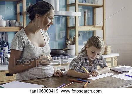 Pregnant mother watching daughter draw View Large Photo Image Stock Photo - Pregnant mother watching daughter draw. Fotosearch