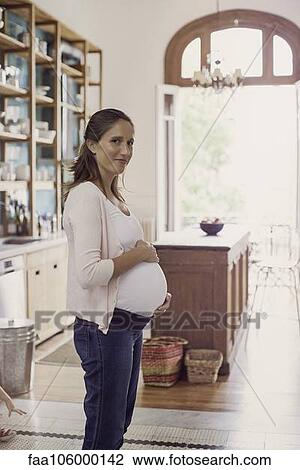 Pregnant woman at home View Large Photo Image Stock Image - Pregnant woman at home. Fotosearch