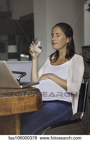 Pregnant woman hydrating View Large Photo Image Stock Photo - Pregnant woman hydrating. Fotosearch