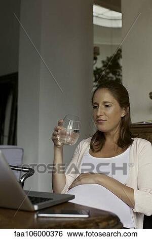 Pregnant woman hydrating View Large Photo Image Stock Photograph - Pregnant woman hydrating. Fotosearch