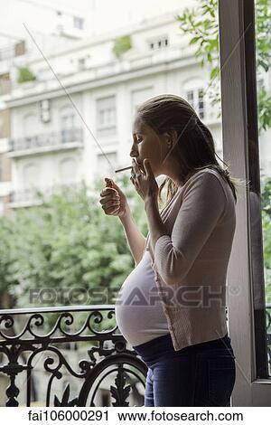 Pregnant woman smoking cigarette View Large Photo Image Stock Image - Pregnant woman smoking cigarette. Fotosearch