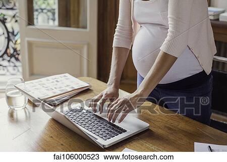 Pregnant woman using laptop computer View Large Photo Image Stock Image - Pregnant woman using laptop computer. Fotosearch