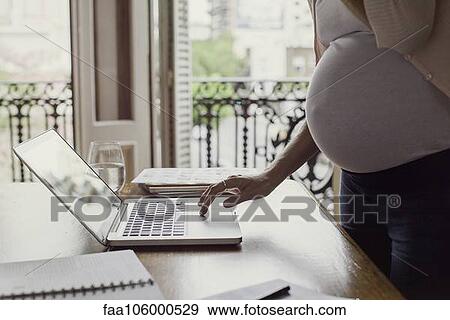 Pregnant woman using laptop computer View Large Photo Image Stock Photo - Pregnant woman using laptop computer. Fotosearch
