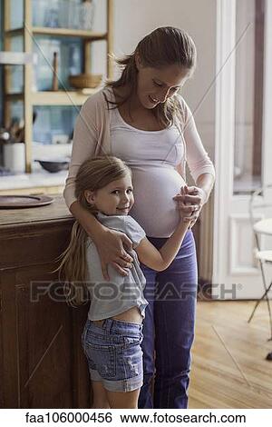 Pregnant woman with young daughter View Large Photo Image Stock Photograph - Pregnant woman with young daughter. Fotosearch