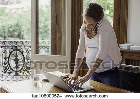 Pregnant woman working from home View Large Photo Image Picture - Pregnant woman working from home. Fotosearch