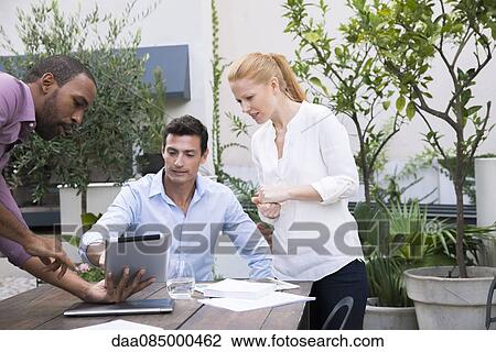 Stock Image - Presenting project proposal with digital tablet. Fotosearch