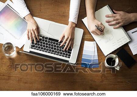 Project team members working side by side View Large Photo Image Stock Photo - Project team members working side by side. Fotosearch