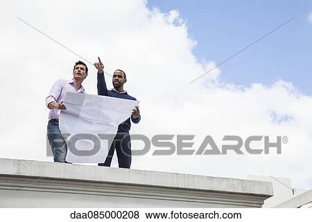Property developer explaining development plan to potential investor View Large Photo Image Stock Photo - Property developer explaining development plan to potential investor. Fotosearch