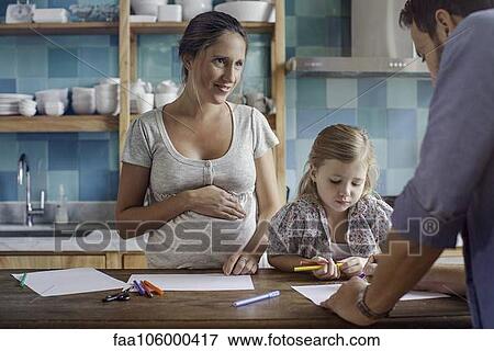 Proud parents watch daughter color coloring book View Large Photo Image Stock Photo - Proud parents watch daughter color coloring book. Fotosearch