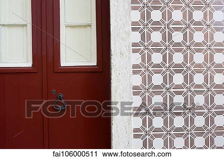 Red door and ornate tiled wall View Large Photo Image Stock Image - Red door and ornate tiled wall. Fotosearch