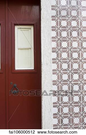 Red door and ornate tiled wall View Large Photo Image Stock Image - Red door and ornate tiled wall. Fotosearch