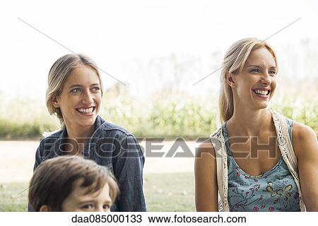 Stock Image - Relaxing in the park with family and friends. Fotosearch