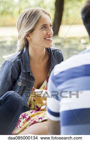 Relaxing in the park with friends View Large Photo Image Picture - Relaxing in the park with friends. Fotosearch
