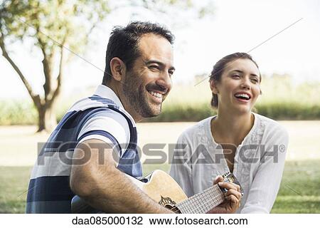 Relaxing in the park with friends View Large Photo Image Stock Image - Relaxing in the park with friends. Fotosearch