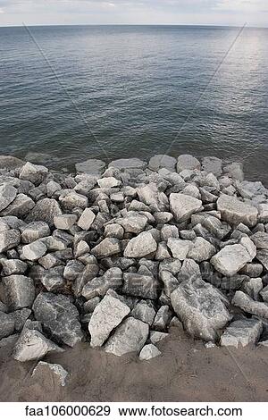 Rocks piled along shore View Large Photo Image Stock Photo - Rocks piled along shore. Fotosearch