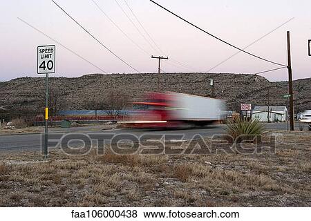 Semi-truck moving on highway View Large Photo Image Stock Photo - Semi-truck moving on highway. Fotosearch