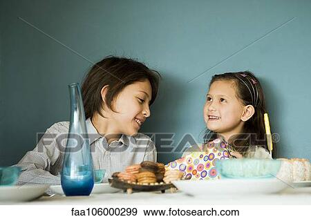 Siblings at birthday party View Large Photo Image Stock Photo - Siblings at birthday party. Fotosearch