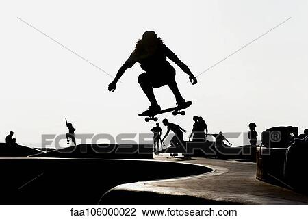 Skateboarder at skate park, silhouetted View Large Photo Image Stock Image - Skateboarder at skate park, silhouetted. Fotosearch