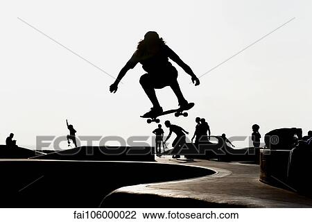 Skateboarder at skate park, silhouetted View Large Photo Image Stock Image - Skateboarder at skate park, silhouetted. Fotosearch