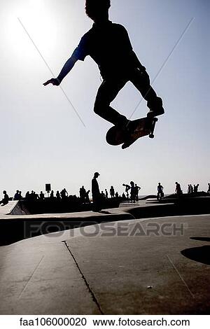 Skateboarder in midair at skate park View Large Photo Image Stock Image - Skateboarder in midair at skate park. Fotosearch