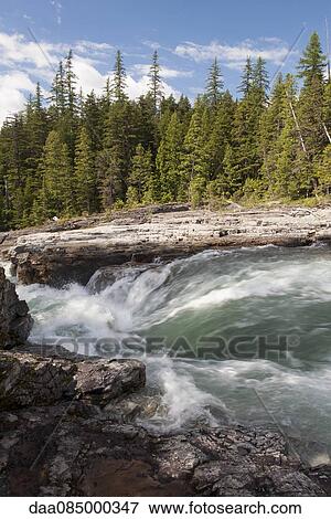 Stock Photo - Stream rushing over rocks in Glacier National Park, Montana, USA. Fotosearch