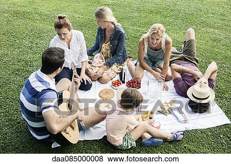 Stock Photo - Summer picnic in the park with family and friends. Fotosearch