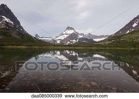 Swiftcurrent Lake and Mount Wilbur in Glacier National Park, Montana, USA View Large Photo Image Stock Photo - Swiftcurrent Lake and Mount Wilbur in Glacier National Park, Montana, USA. Fotosearch