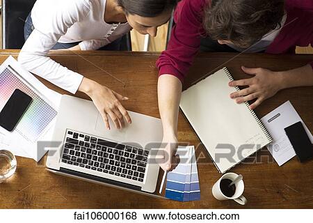 Team members collaborating on project View Large Photo Image Stock Photo - Team members collaborating on project. Fotosearch