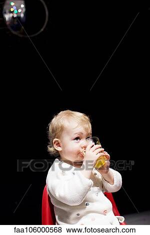 Toddler drinking juice View Large Photo Image Stock Photo - Toddler drinking juice. Fotosearch