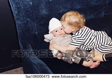 Toddler embracing infant sibling View Large Photo Image Stock Image - Toddler embracing infant sibling. Fotosearch